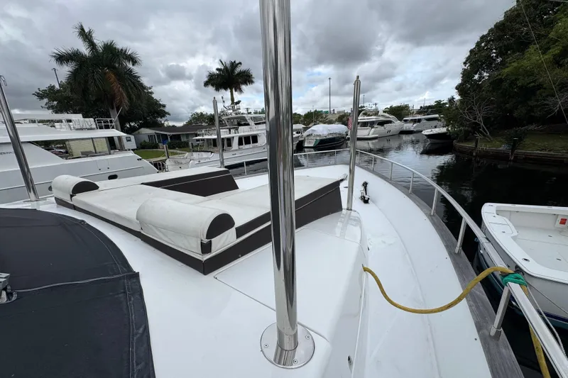 Slide: The Image of 1998 Azimut 85 Ultimate yacht docked, featuring spacious deck and luxurious seating. - 7