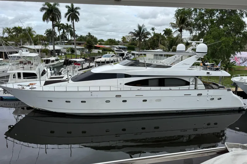 Slide: The Image of Luxury 1998 Azimut 85 Ultimate yacht docked, surrounded by palm trees and other boats. - 0