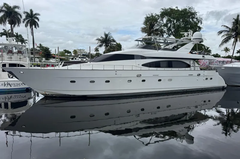 Slide: The Image of Luxurious 1998 Azimut 85 Ultimate yacht docked, reflecting on calm water. - 1