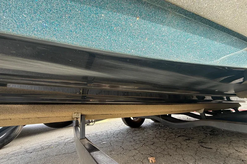 Slide: The Image of 2013 Ranger Z520C Carbon Comanche boat hull on trailer, showcasing sleek design and glitter finish. - 10