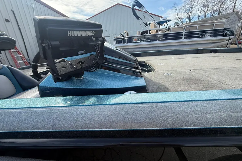 Slide: The Image of 2013 Ranger Z520C Carbon Comanche boat with Humminbird fish finder, parked near other boats. - 14