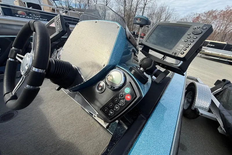 Slide: The Image of 2013 Ranger Z520C Carbon Comanche boat dashboard with steering wheel and electronic display. - 17