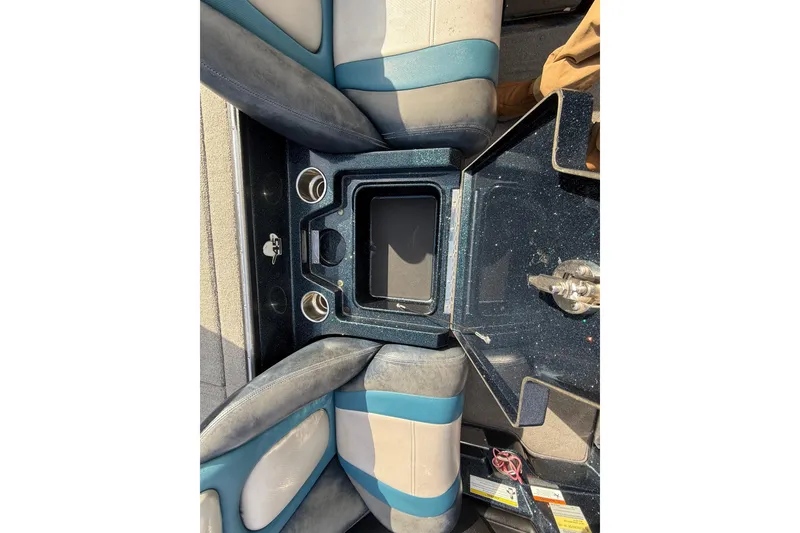 Slide: The Image of 2013 Ranger Z520C Carbon Comanche boat interior with storage compartment and cup holders. - 35