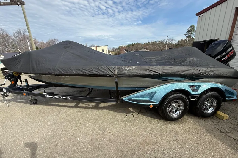Slide: The Image of 2013 Ranger Z520C Carbon Comanche boat covered on trailer, parked outdoors. - 43