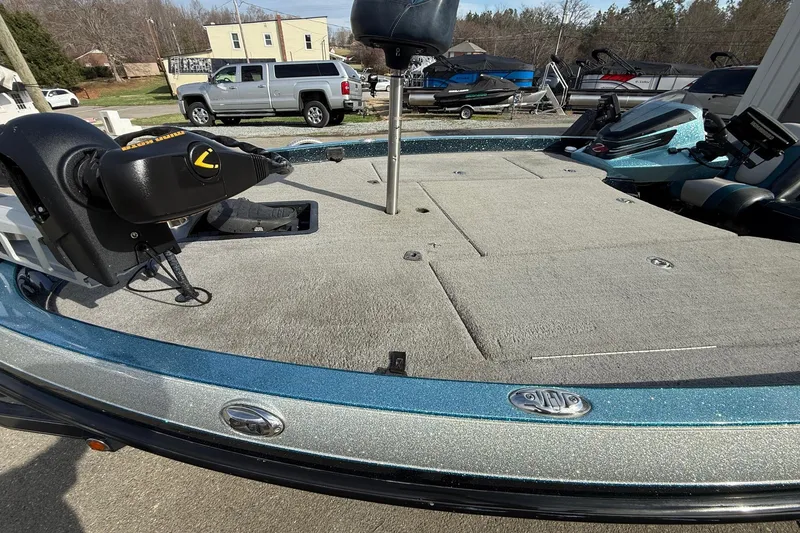 Slide: The Image of 2013 Ranger Z520C Carbon Comanche boat deck with trolling motor, parked outdoors. - 5