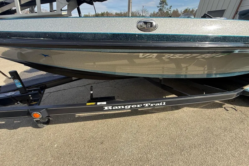 Slide: The Image of 2013 Ranger Z520C Carbon Comanche boat on Ranger Trail trailer, parked on pavement. - 6