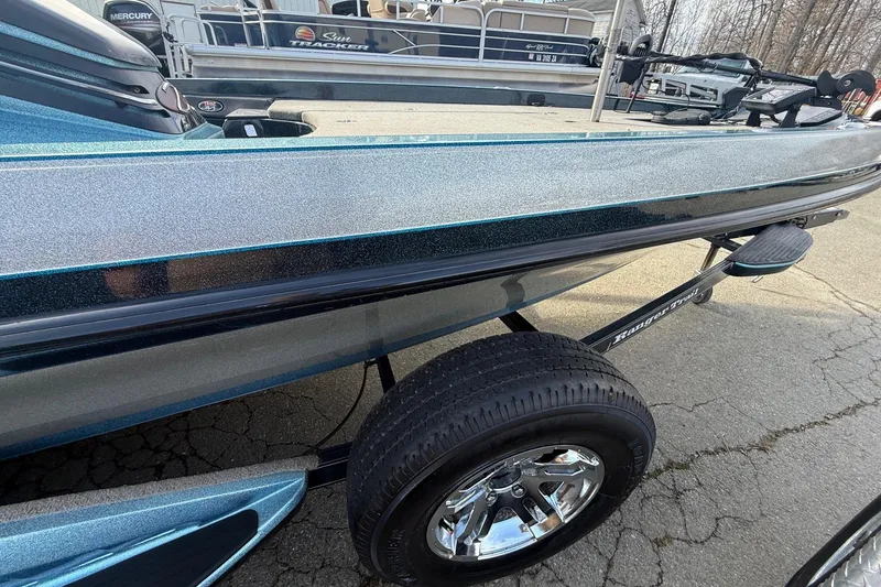 Slide: The Image of 2013 Ranger Z520C Carbon Comanche boat on trailer, metallic finish, parked outdoors. - 16