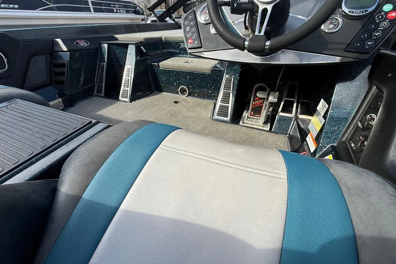 Slide: The Image of Interior of 2013 Ranger Z520C Carbon Comanche boat, featuring steering wheel and controls. - 21