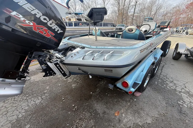 Slide: The Image of 2013 Ranger Z520C Carbon Comanche boat with Mercury Pro XS engine, parked outdoors. - 24