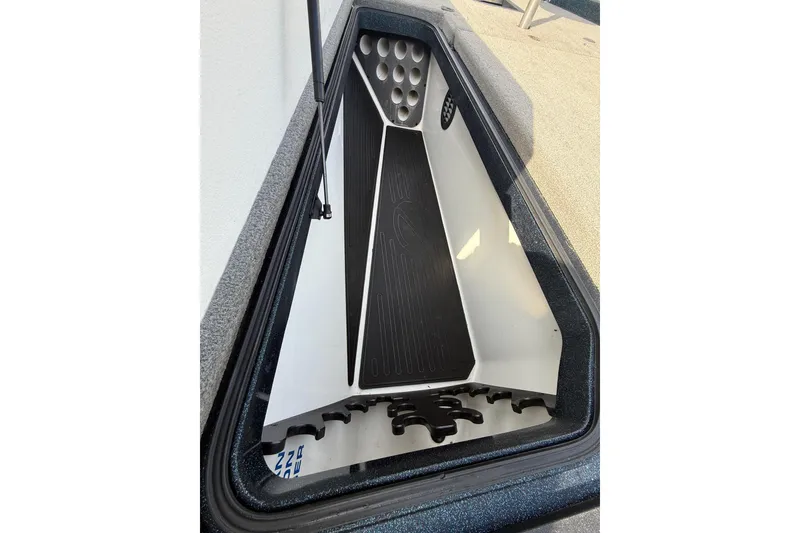 Slide: The Image of 2013 Ranger Z520C Carbon Comanche boat storage compartment with rod holders. - 26