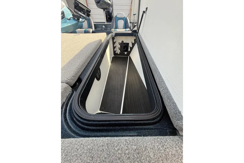 Slide: The Image of 2013 Ranger Z520C Carbon Comanche boat storage compartment, open and empty. - 27