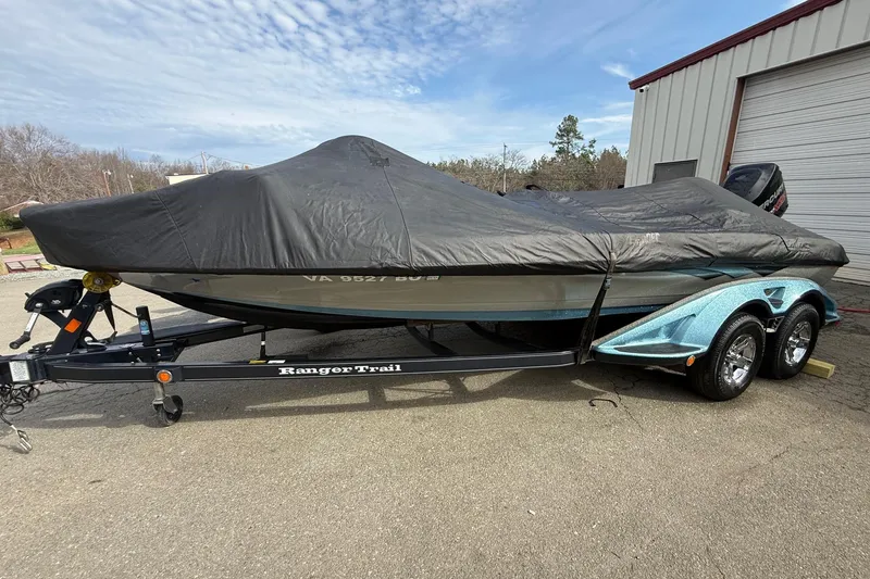 Slide: The Image of 2013 Ranger Z520C Carbon Comanche boat covered on trailer, parked outdoors. - 44