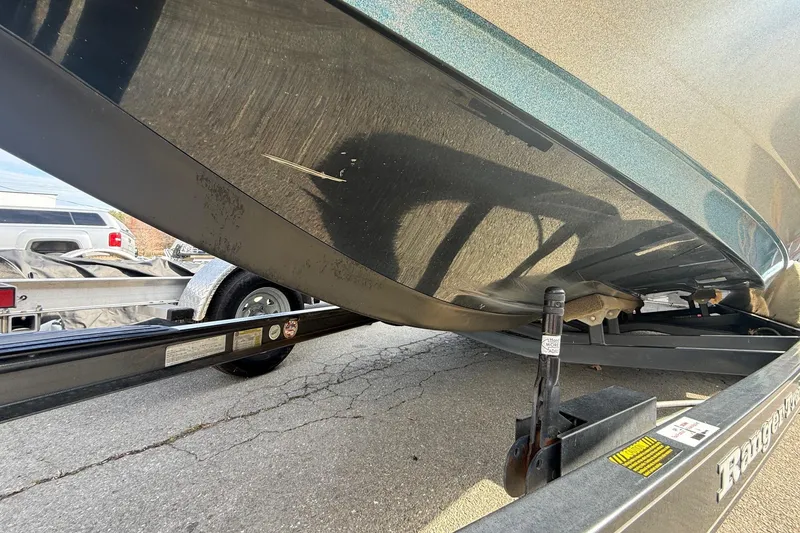 Slide: The Image of 2013 Ranger Z520C Carbon Comanche boat on trailer, showing hull and trailer details. - 8