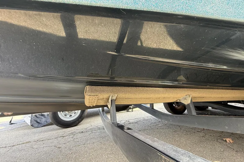 Slide: The Image of 2013 Ranger Z520C Carbon Comanche boat on trailer, showing hull and support structure. - 9