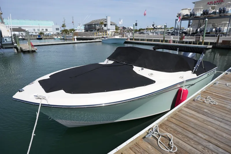 Slide: The Image of 2017 Grady-White Freedom 205 boat docked at marina with cover. - 10