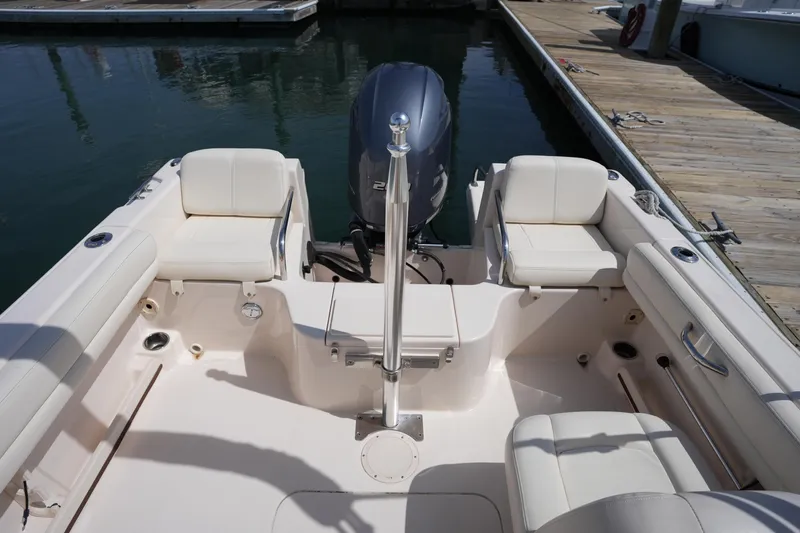 Slide: The Image of 2017 Grady-White Freedom 205 boat interior with seating and motor at dock. - 12
