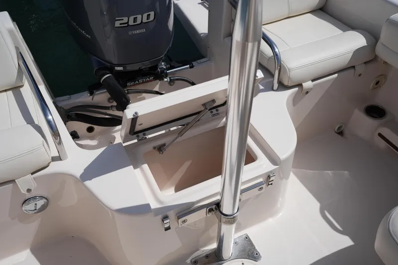 Slide: The Image of 2017 Grady-White Freedom 205 boat interior with Yamaha 200 engine and seating area. - 13