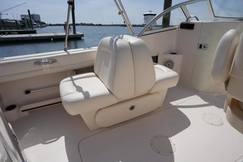 Slide: The Image of 2017 Grady-White Freedom 205 boat interior with white seating and waterfront view. - 14