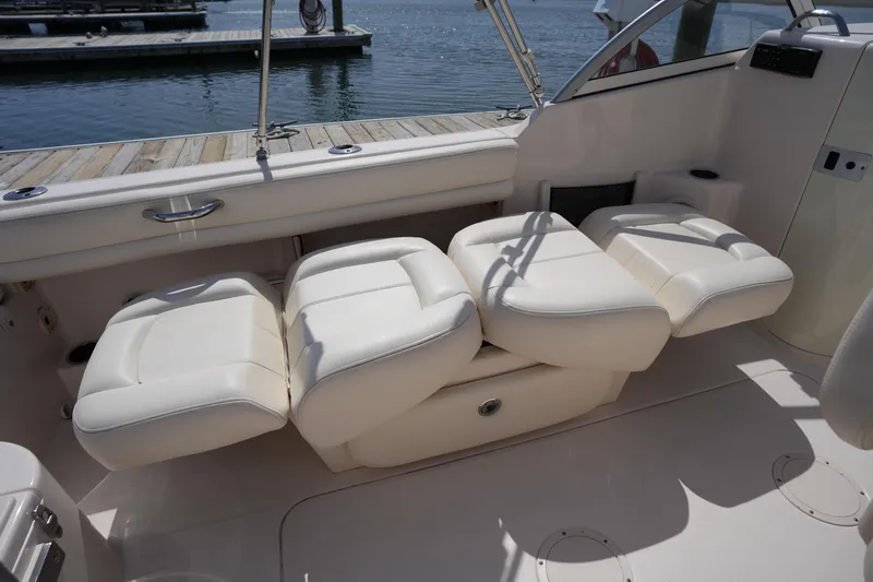 Slide: The Image of 2017 Grady-White Freedom 205 boat interior with white cushioned seating. - 15