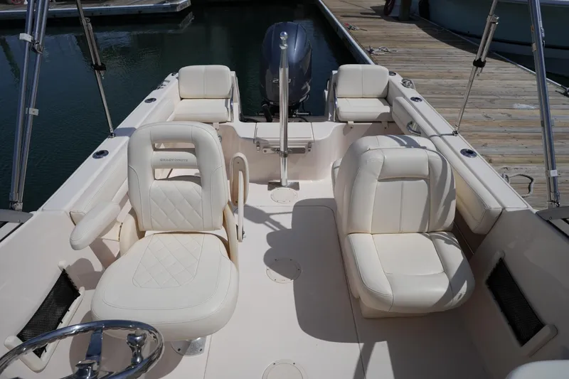 Slide: The Image of 2017 Grady-White Freedom 205 boat interior with white seating and steering wheel. - 17