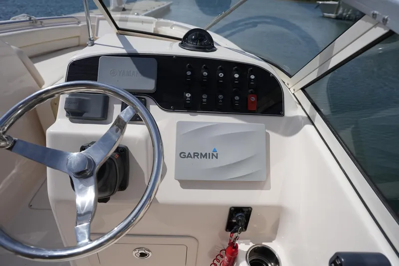 Slide: The Image of 2017 Grady-White Freedom 205 boat dashboard with Garmin navigation system and steering wheel. - 18