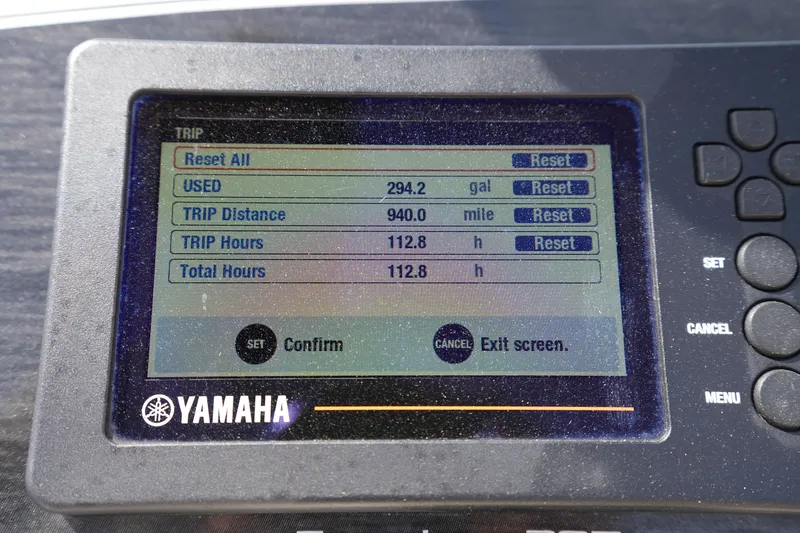 Slide: The Image of Yamaha display showing trip data: 294.2 gallons used, 940 miles traveled, 112.8 hours. Grady-White Freedom 205. - 20