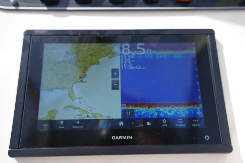 Slide: The Image of Garmin navigation display on 2017 Grady-White Freedom 205 boat, showing map and sonar data. - 23