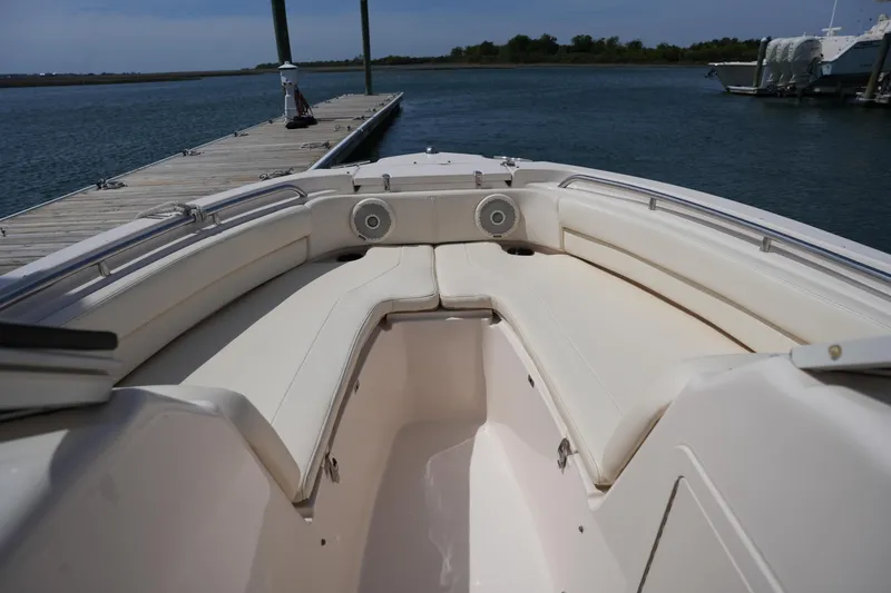 Slide: The Image of 2017 Grady-White Freedom 205 boat interior with white seating at dock. - 27