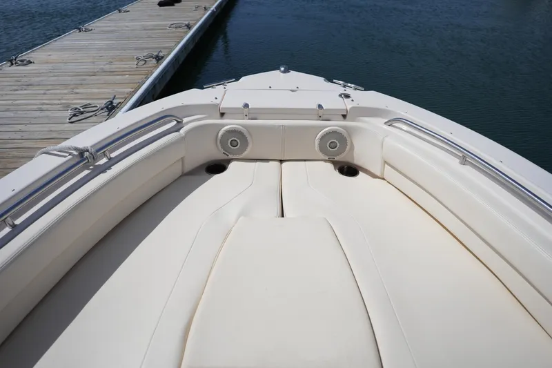 Slide: The Image of 2017 Grady-White Freedom 205 boat interior with cushioned seating and dock view. - 29