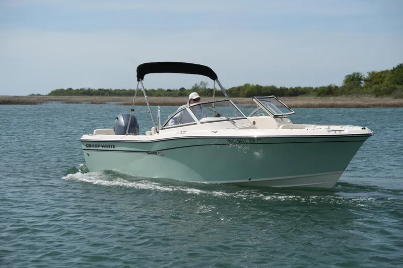 Slide: The Image of 2017 Grady-White Freedom 205 boat cruising on a calm lake under a clear sky. - 3