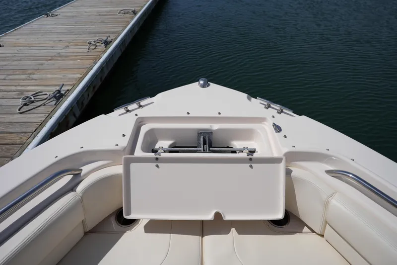 Slide: The Image of 2017 Grady-White Freedom 205 boat interior at dock, showcasing seating and storage. - 30