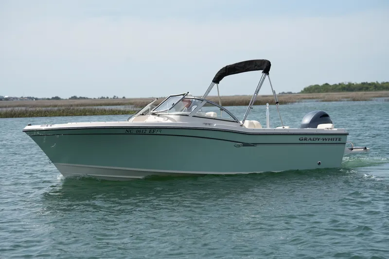 Slide: The Image of 2017 Grady-White Freedom 205 boat cruising on calm water. - 4