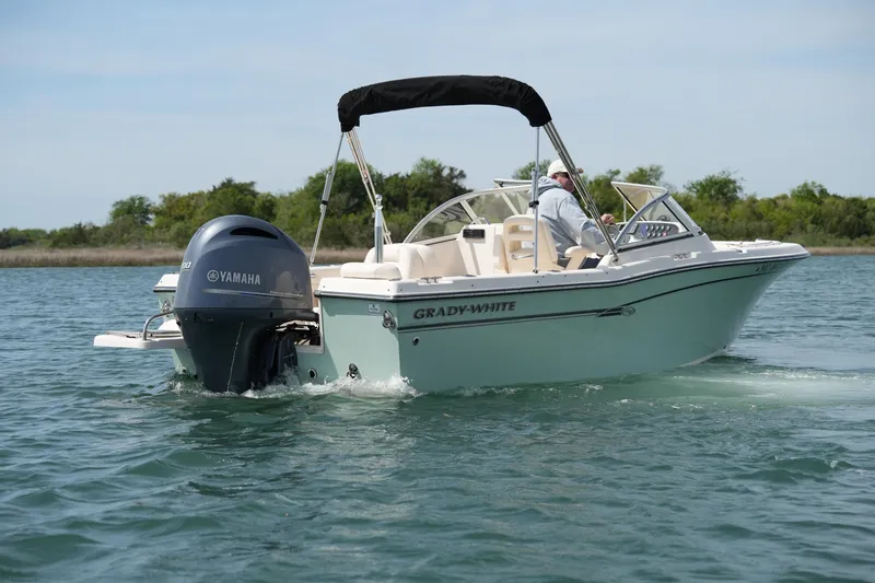 Slide: The Image of 2017 Grady-White Freedom 205 boat cruising on a calm lake with Yamaha engine. - 6