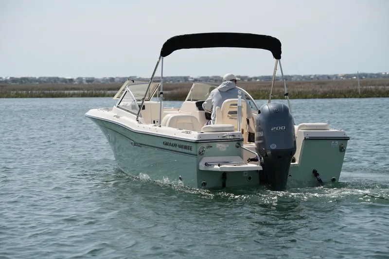 Slide: The Image of 2017 Grady-White Freedom 205 boat cruising on calm water. - 7