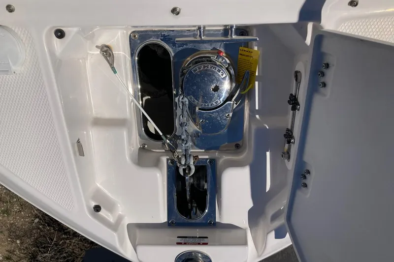 Slide: The Image of 2022 Chaparral 267 SSX OB boat anchor compartment with winch and cables. - 14