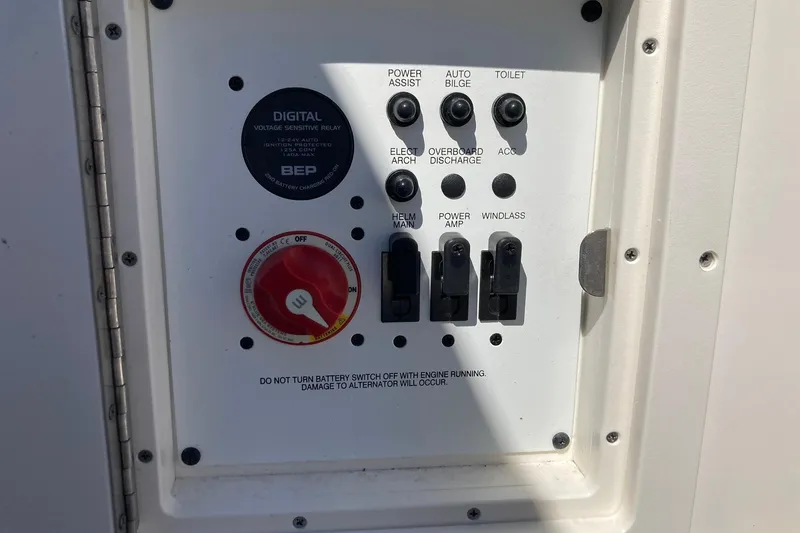 Slide: The Image of Control panel of 2022 Chaparral 267 SSX OB boat with switches and voltage relay. - 19