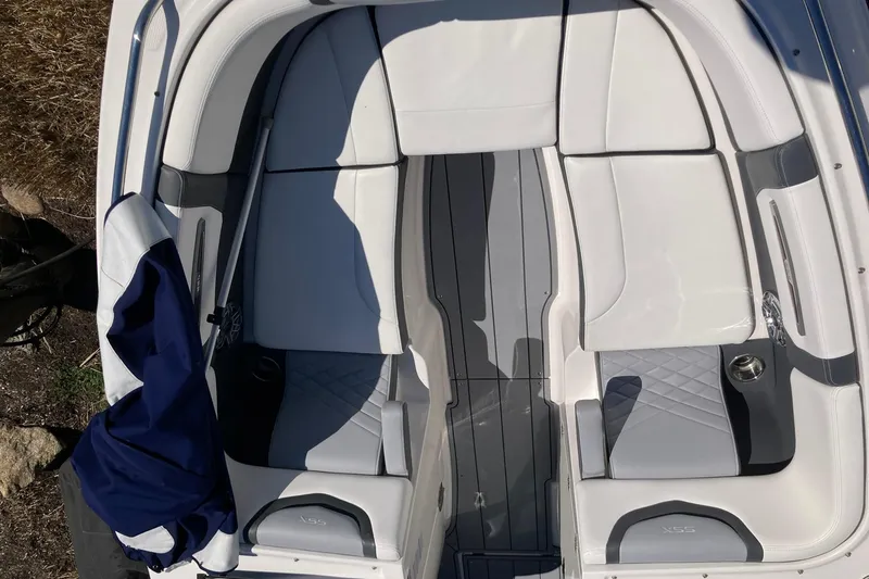 Slide: The Image of 2022 Chaparral 267 SSX OB boat interior with white and gray seating. - 20
