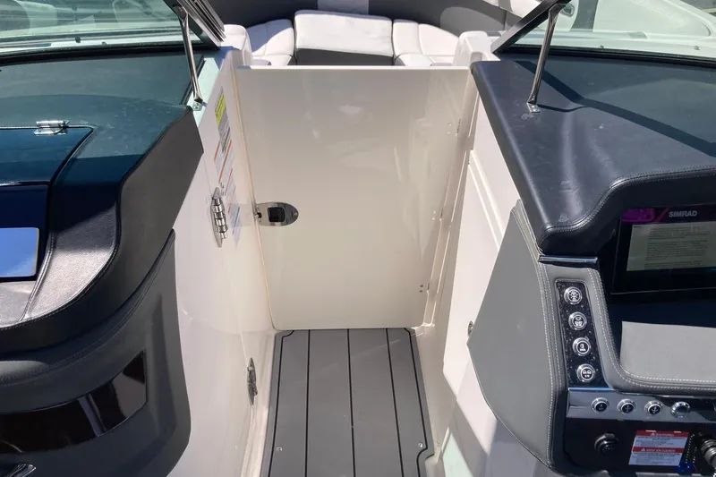 Slide: The Image of 2022 Chaparral 267 SSX OB boat interior with modern dashboard and seating area. - 22