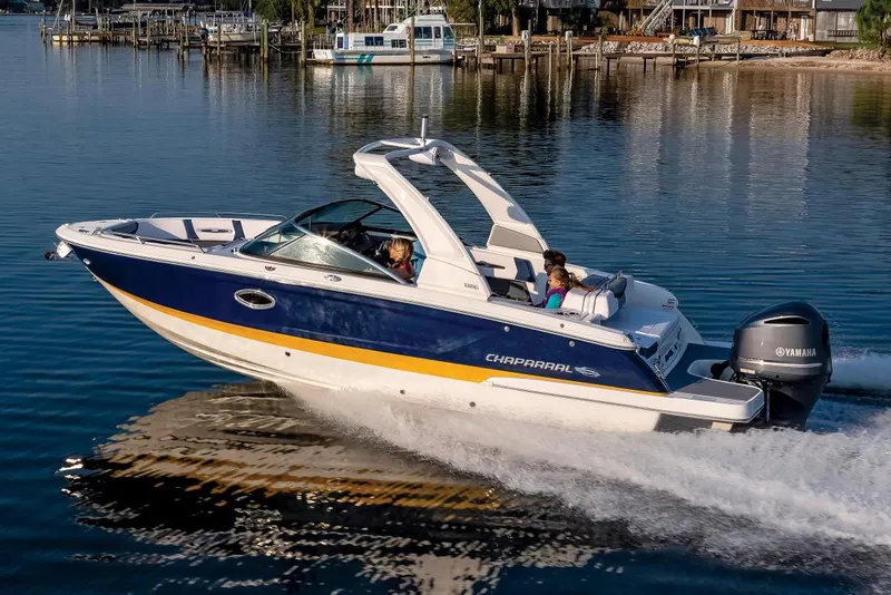 Slide: The Image of Manufacturer Provided Image: 2022 Chaparral 267 SSX OB boat cruising on a calm lake near a marina. - 23