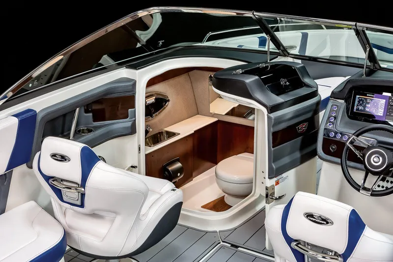 Slide: The Image of Manufacturer Provided Image: 2022 Chaparral 267 SSX OB boat interior with helm, seating, and cabin amenities. - 41