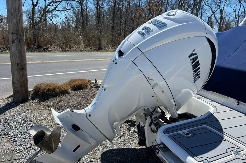 Slide: The Image of 2022 Chaparral 267 SSX OB with Yamaha outboard motor, parked outdoors. - 6