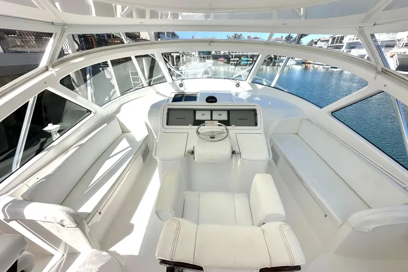 Slide: The Image of 2012 Viking 42 Open yacht helm with white seating and panoramic windows. - 10