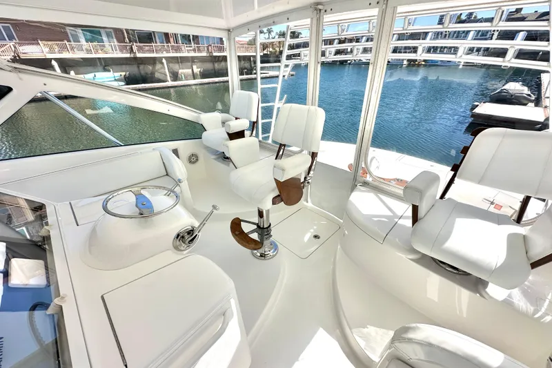Slide: The Image of Interior view of 2012 Viking 42 Open yacht with white seating and helm. - 12