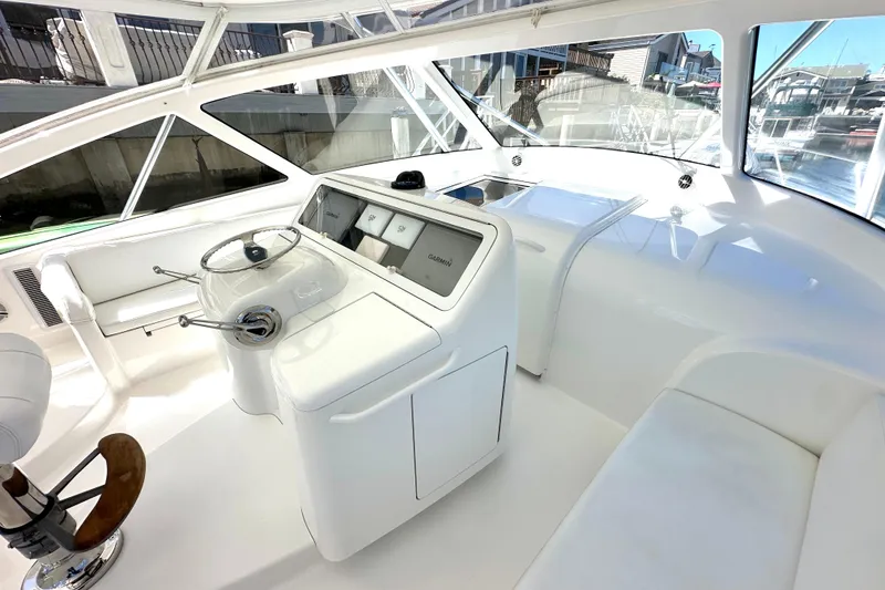 Slide: The Image of 2012 Viking 42 Open yacht helm with modern controls and panoramic windows. - 14