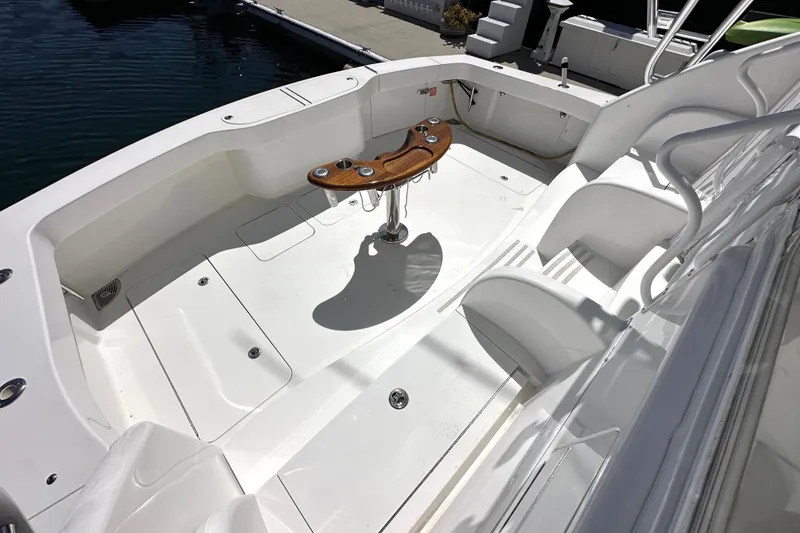 Slide: The Image of 2012 Viking 42 Open boat deck with seating and wooden table. - 18
