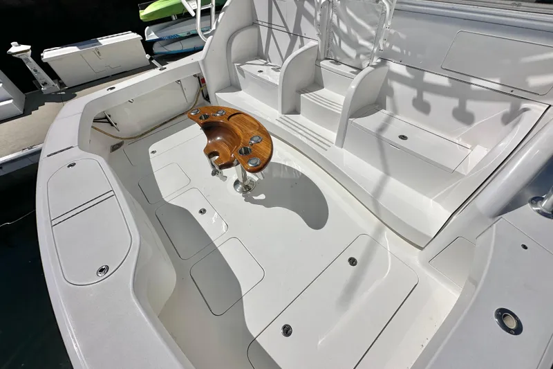 Slide: The Image of 2012 Viking 42 Open boat cockpit with seating and wooden fishing rod holder. - 19