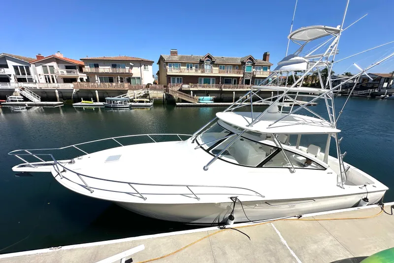 Slide: The Image of 2012 Viking 42 Open yacht docked in a scenic waterfront marina. - 2