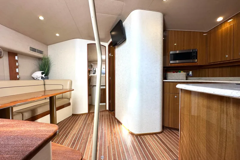 Slide: The Image of Interior of 2012 Viking 42 Open yacht with modern kitchen and seating area. - 28