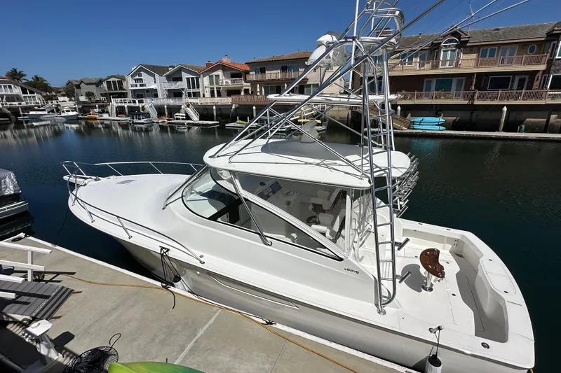 Slide: The Image of 2012 Viking 42 Open yacht docked in a serene marina setting. - 3
