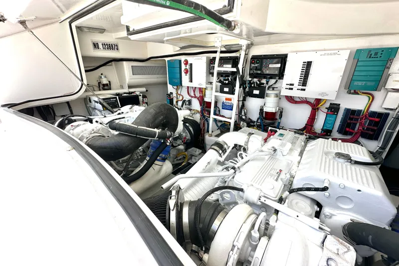 Slide: The Image of Engine room of a 2012 Viking 42 Open yacht, showcasing machinery and wiring. - 33